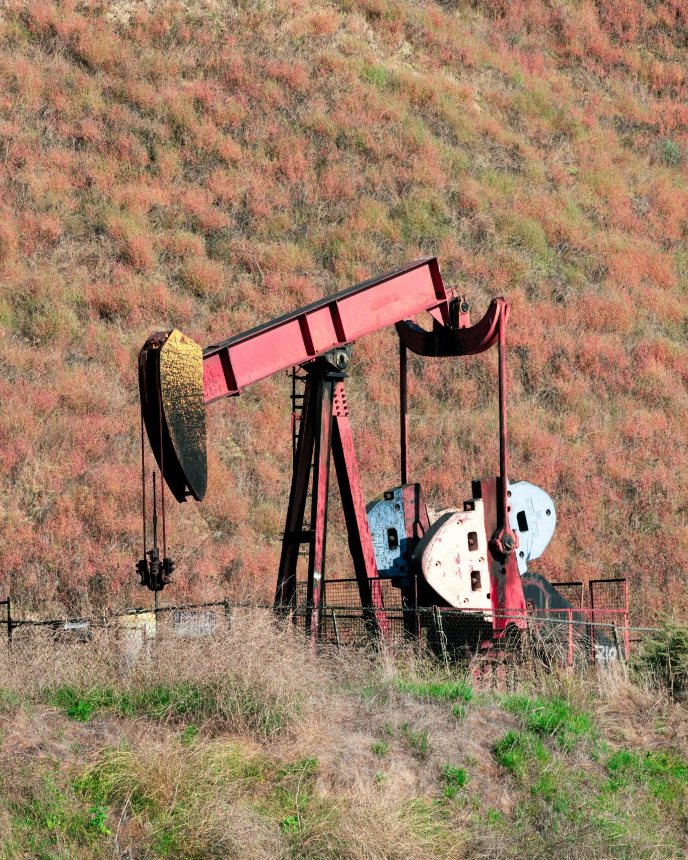 Pumpjack against rolling hills